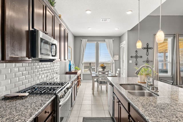386 Nautical Loop, Kyle, TX 78640 - kitchen featuring a sink, appliances with stainless steel finishes, dark brown cabinetry, backsplash, and recessed lighting