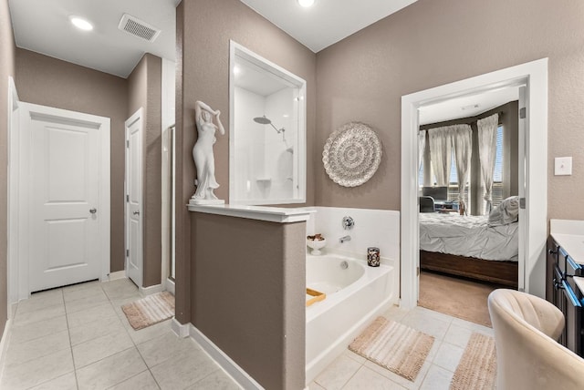 386 Nautical Loop, Kyle, TX 78640 - full bath with ensuite bath, tile patterned flooring, walk in shower, and a garden tub