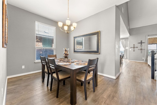 386 Nautical Loop, Kyle, TX 78640 - dining area with a chandelier, baseboards, and wood finished floors