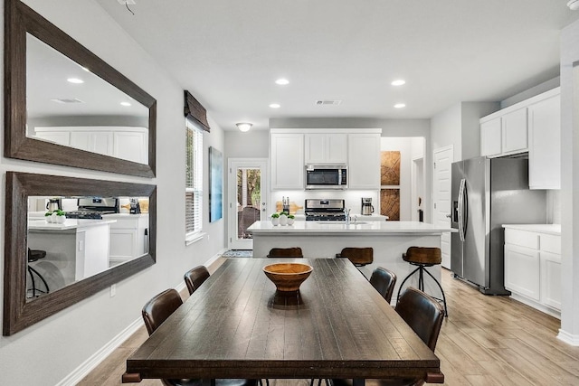 dining space with visible vents, recessed lighting, light wood-type flooring, and baseboards