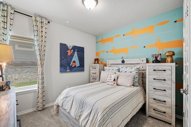 carpeted bedroom with baseboards and a textured ceiling