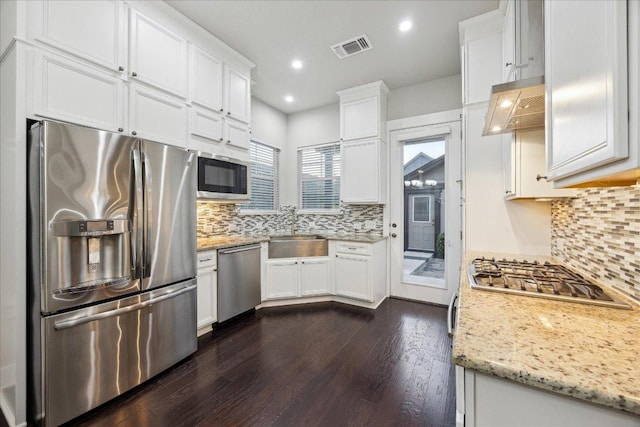 7508 Pantherpaw St, Austin, TX 78757 - kitchen featuring appliances with stainless steel finishes, a sink, white cabinets, and recessed lighting