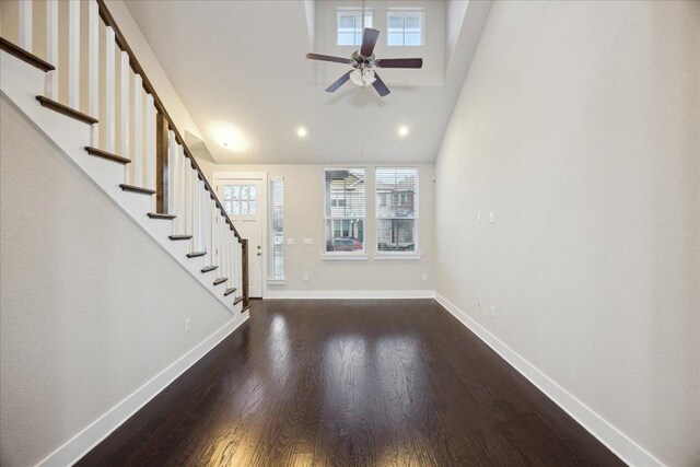 7508 Pantherpaw St, Austin, TX 78757 - foyer entrance with plenty of natural light, dark wood-style floors, stairs, ceiling fan, and high vaulted ceiling