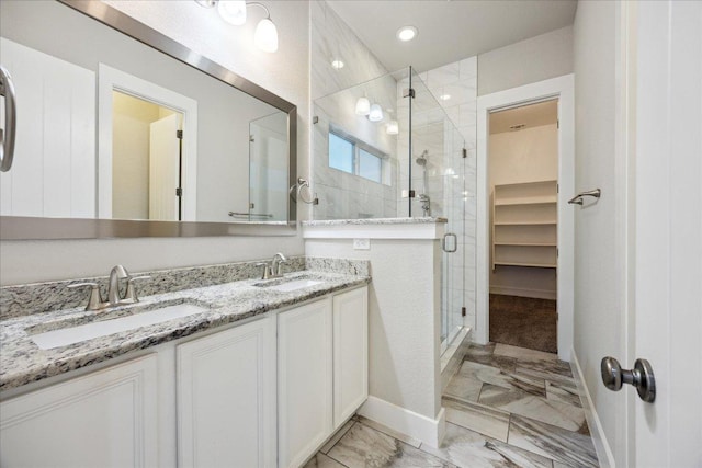 7508 Pantherpaw St, Austin, TX 78757 - bathroom featuring marble finish flooring, a shower stall, double vanity, and baseboards