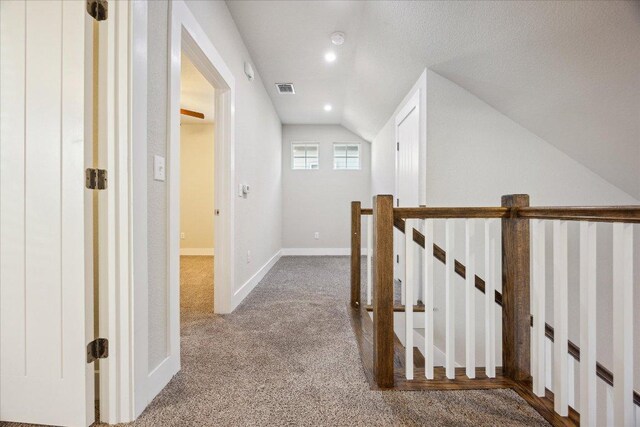 7508 Pantherpaw St, Austin, TX 78757 - corridor with lofted ceiling, carpet, and an upstairs landing