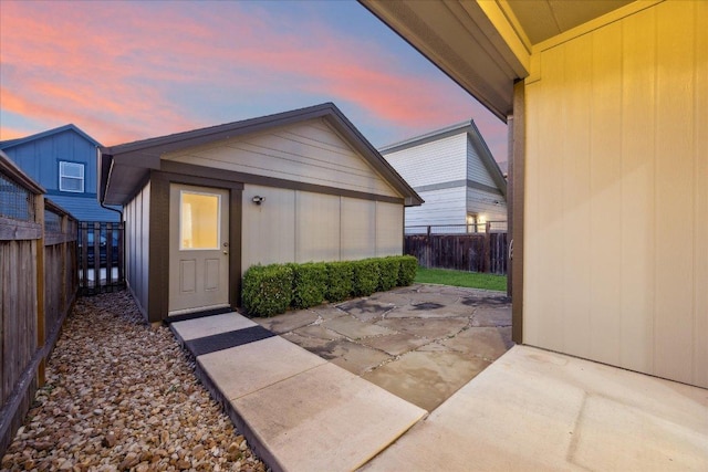 7508 Pantherpaw St, Austin, TX 78757 - exterior entry at dusk with a patio area