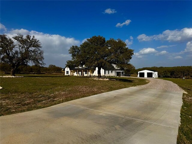 871 Blackbuck Ridge Dr, Lampasas, TX 76550 - view of front of house featuring a front yard, a detached garage, an outbuilding, and driveway