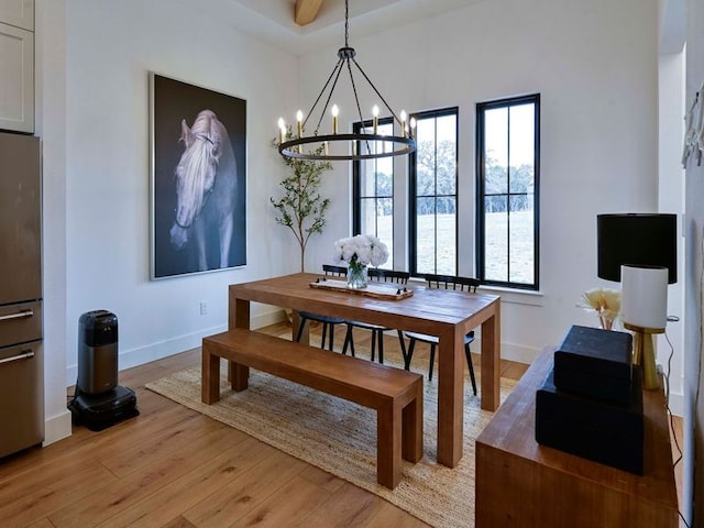 871 Blackbuck Ridge Dr, Lampasas, TX 76550 - dining area with a notable chandelier, baseboards, and light wood finished floors