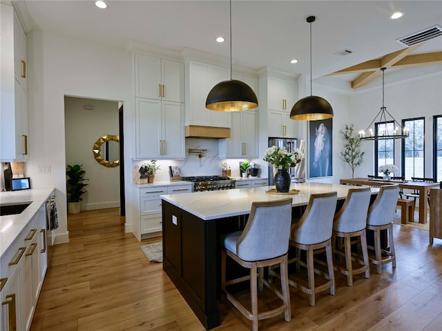 871 Blackbuck Ridge Dr, Lampasas, TX 76550 - kitchen with light wood-type flooring, visible vents, decorative backsplash, and freestanding refrigerator