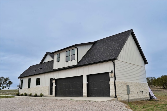 871 Blackbuck Ridge Dr, Lampasas, TX 76550 - view of side of home featuring stone siding, board and batten siding, a shingled roof, and driveway