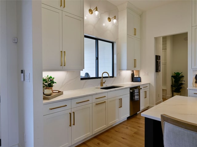871 Blackbuck Ridge Dr, Lampasas, TX 76550 - kitchen featuring white cabinetry, light stone counters, light wood finished floors, and a sink