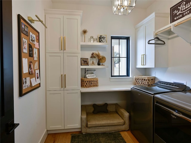 871 Blackbuck Ridge Dr, Lampasas, TX 76550 - laundry area featuring washer and dryer, cabinet space, light wood-style floors, and a chandelier