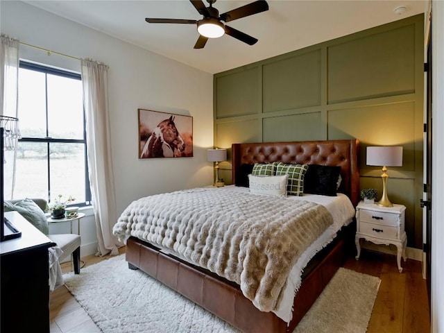 871 Blackbuck Ridge Dr, Lampasas, TX 76550 - bedroom with a decorative wall, multiple windows, wood finished floors, and ceiling fan