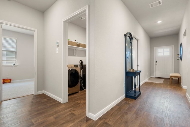 321 Cherry Laurel Ln, Kyle, TX 78640 - hallway featuring washer / clothes dryer, dark wood-style flooring, baseboards, and visible vents