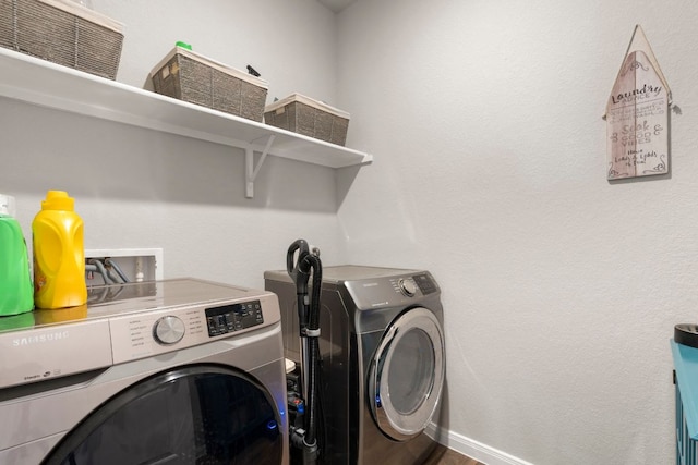 321 Cherry Laurel Ln, Kyle, TX 78640 - laundry area with laundry area, baseboards, and washing machine and clothes dryer