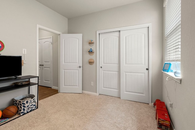 321 Cherry Laurel Ln, Kyle, TX 78640 - bedroom featuring a closet, carpet, and multiple windows