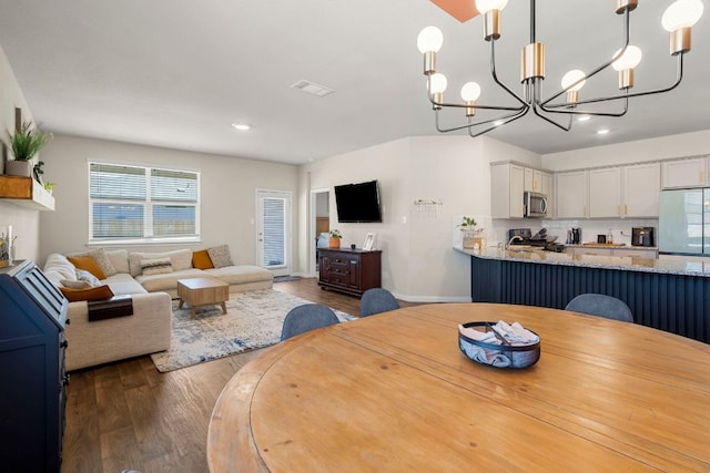 321 Cherry Laurel Ln, Kyle, TX 78640 - dining space with an inviting chandelier, visible vents, baseboards, dark wood-style floors, and recessed lighting