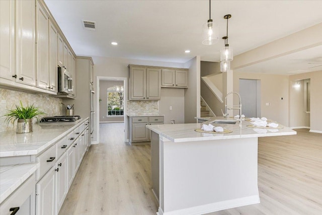 9201 Cessna Ln, Austin, TX 78717 - kitchen with a sink, light wood-type flooring, appliances with stainless steel finishes, tasteful backsplash, and recessed lighting