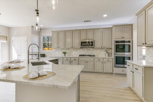9201 Cessna Ln, Austin, TX 78717 - kitchen featuring appliances with stainless steel finishes, a sink, decorative backsplash, healthy amount of natural light, and recessed lighting