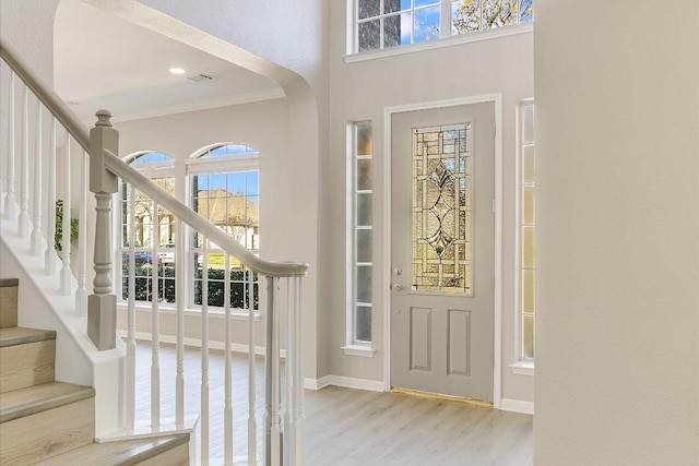 9201 Cessna Ln, Austin, TX 78717 - entrance foyer featuring wood finished floors, stairs, crown molding, arched walkways, and a high ceiling