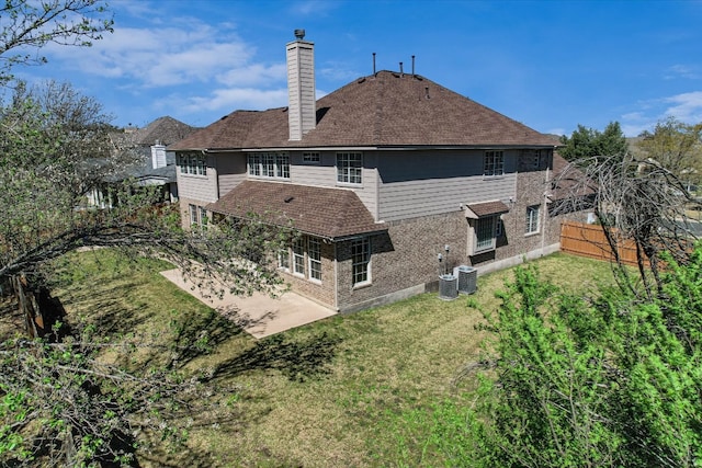 9201 Cessna Ln, Austin, TX 78717 - rear view of property featuring a chimney, a patio area, a shingled roof, cooling unit, and brick siding