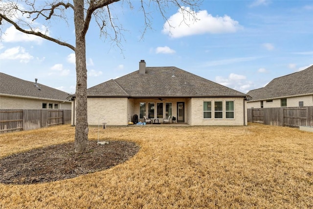 1737 Kerr Valley Ln, College Station, TX 77845 - rear view of house with a ceiling fan, a chimney, a patio area, and brick siding