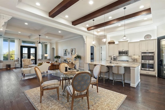 9525 Stratus Dr, Dripping Springs, TX 78620 - dining space with arched walkways, ceiling fan, beamed ceiling, dark wood-style floors, and recessed lighting