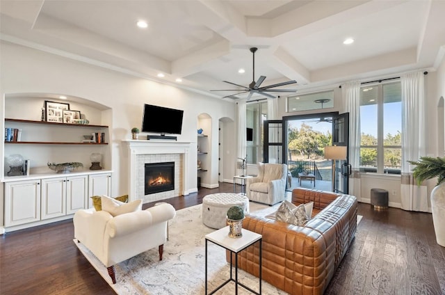 9525 Stratus Dr, Dripping Springs, TX 78620 - living area featuring arched walkways, a tile fireplace, coffered ceiling, dark wood-type flooring, and ceiling fan