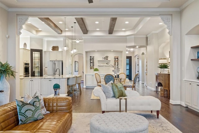 9525 Stratus Dr, Dripping Springs, TX 78620 - living area featuring arched walkways, dark wood-type flooring, recessed lighting, beam ceiling, and crown molding