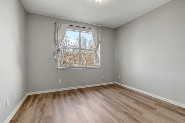 512 Eberhart Ln Unit 1207, Austin, TX 78745 - unfurnished room featuring wood finished floors and baseboards