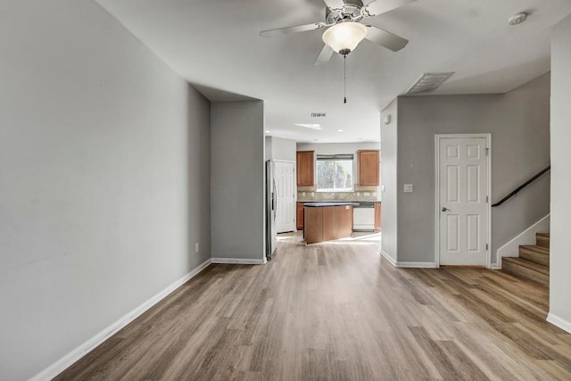 512 Eberhart Ln Unit 1207, Austin, TX 78745 - unfurnished living room featuring light wood-style flooring and baseboards