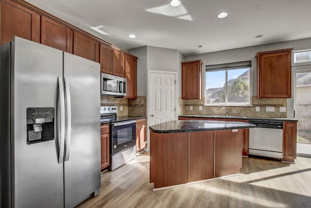 512 Eberhart Ln Unit 1207, Austin, TX 78745 - kitchen with stainless steel appliances, light wood-style floors, a center island, a sink, and recessed lighting