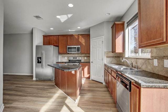 512 Eberhart Ln Unit 1207, Austin, TX 78745 - kitchen with appliances with stainless steel finishes, a sink, a center island, light wood-type flooring, and recessed lighting