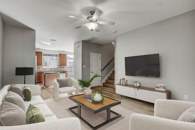 512 Eberhart Ln Unit 1207, Austin, TX 78745 - living area featuring light wood-type flooring, ceiling fan, and stairs