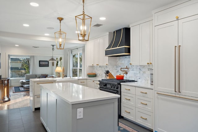 3506 Clearview Dr, Austin, TX 78703 - kitchen with paneled built in fridge, wall chimney exhaust hood, healthy amount of natural light, light countertops, and recessed lighting