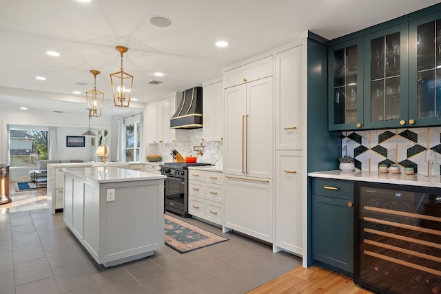 3506 Clearview Dr, Austin, TX 78703 - kitchen featuring beverage cooler, gas stove, wall chimney exhaust hood, light countertops, and paneled refrigerator