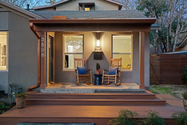 3506 Clearview Dr, Austin, TX 78703 - doorway to property featuring stucco siding, a porch, and a shingled roof