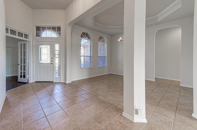 120 Mountain Laurel Way, Austin, TX 78737 - entrance foyer featuring light tile patterned floors, a raised ceiling, a chandelier, arched walkways, and crown molding