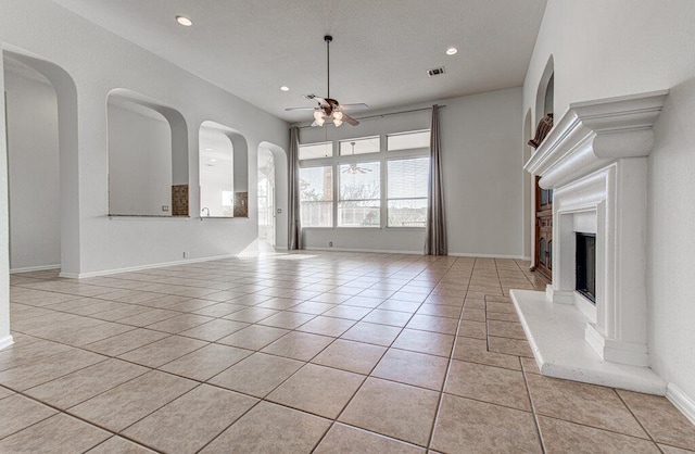 120 Mountain Laurel Way, Austin, TX 78737 - unfurnished living room with ceiling fan, light tile patterned flooring, recessed lighting, a fireplace with raised hearth, and baseboards
