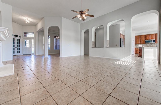 120 Mountain Laurel Way, Austin, TX 78737 - unfurnished living room featuring light tile patterned floors, ceiling fan, and arched walkways