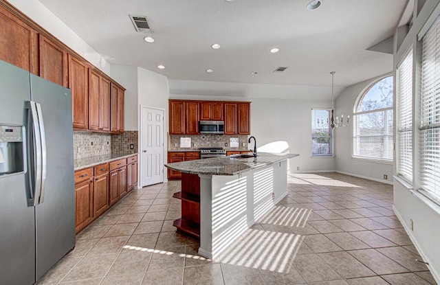 120 Mountain Laurel Way, Austin, TX 78737 - kitchen with stainless steel appliances, a sink, decorative backsplash, a chandelier, and light tile patterned floors