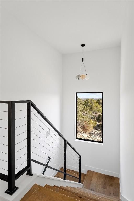 106 Bella Montagna Cir, Austin, TX 78734 - stairs featuring wood finished floors and baseboards