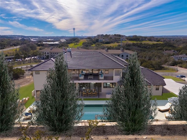 106 Bella Montagna Cir, Austin, TX 78734 - rear view of house featuring a tiled roof, an outdoor pool, stucco siding, a patio area, and outdoor dining area