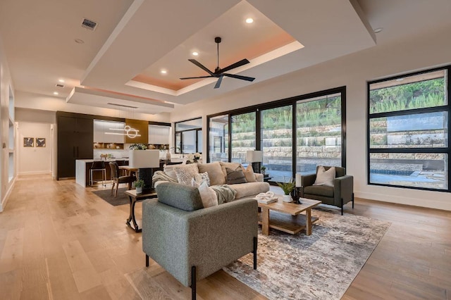 106 Bella Montagna Cir, Austin, TX 78734 - living room with a tray ceiling, ceiling fan, light wood finished floors, and recessed lighting