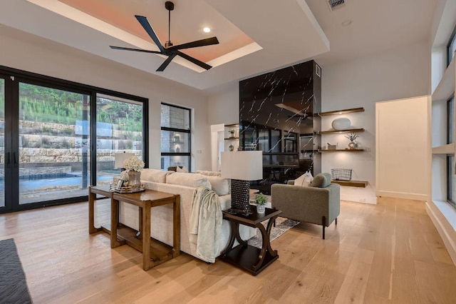 106 Bella Montagna Cir, Austin, TX 78734 - living room with a raised ceiling, ceiling fan, light wood-style flooring, and recessed lighting