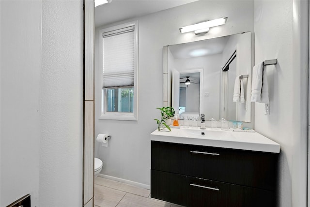 1205 Westmoor Dr, Austin, TX 78723 - bathroom featuring vanity, toilet, a ceiling fan, and baseboards