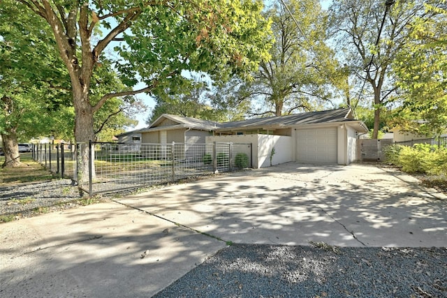 1205 Westmoor Dr, Austin, TX 78723 - view of front facade featuring concrete driveway, a garage, and a gate
