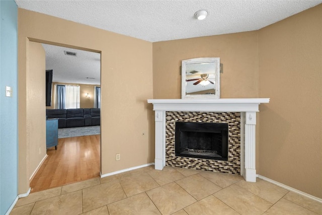 2103 Heather Dr, Cedar Park, TX 78613 - unfurnished living room with a fireplace, a textured ceiling, tile patterned flooring, and a ceiling fan