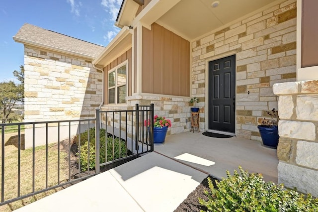 property entrance with stone siding and board and batten siding