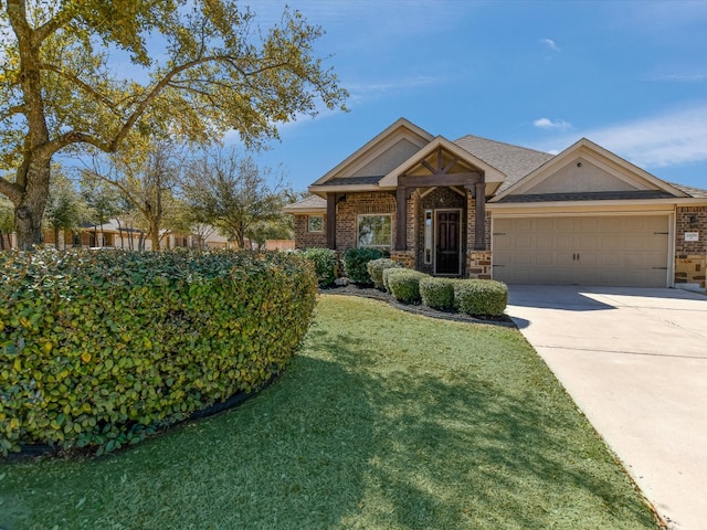 2829 Homecoming, Leander, TX 78641 - view of front of house with brick siding, concrete driveway, a garage, and a front yard